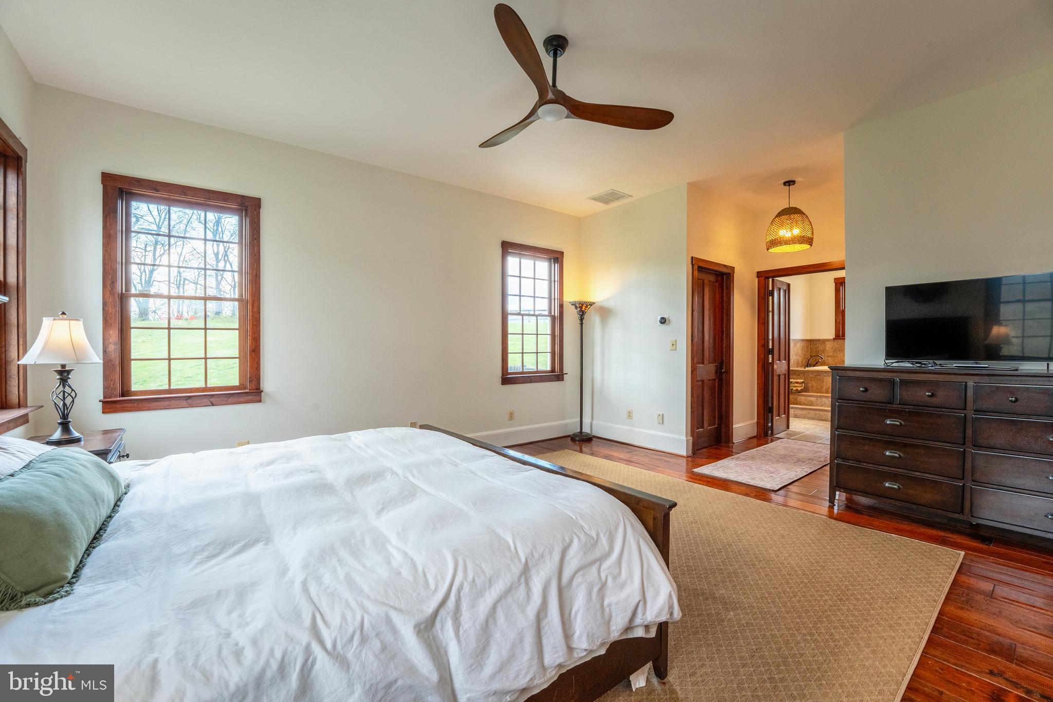 15718 Old Waterford Road Waterford, VA 20197 - Photo 33 of 81 a bedroom with a bed and a flat tv screen on dresser