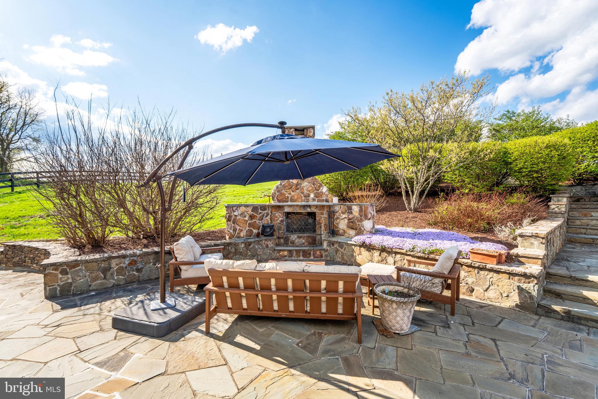 15718 Old Waterford Road Waterford, VA 20197 - Photo 65 of 81 a view of an outdoor sitting area with couch and umbrella