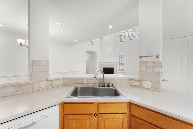 a kitchen with a sink a stove and cabinets