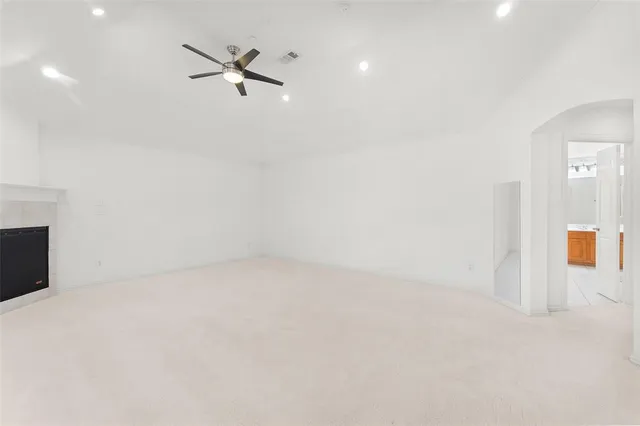 a view of an empty room with a ceiling fan