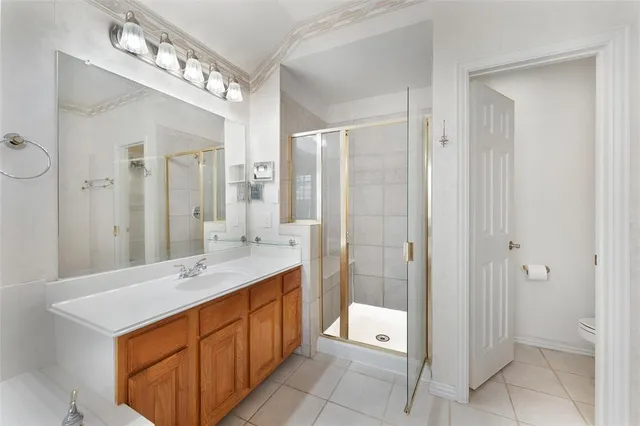 a spacious bathroom with a tub sink and mirror