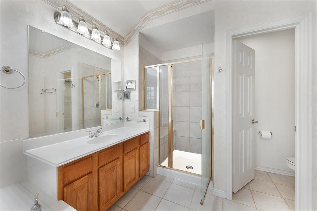 8108 Locust Street Irving, TX 75063 - Photo 18 of 39 a bathroom with a double vanity sink mirror and shower