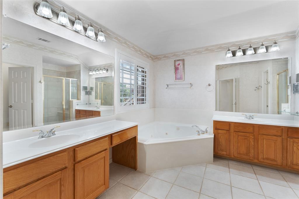 8108 Locust Street Irving, TX 75063 - Photo 19 of 39 a spacious bathroom with a tub sink and mirror