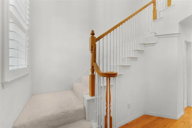 an empty room with a window and a ceiling fan