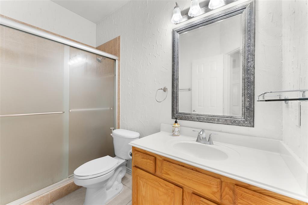 8108 Locust Street Irving, TX 75063 - Photo 25 of 39 a bathroom with a sink and a mirror
