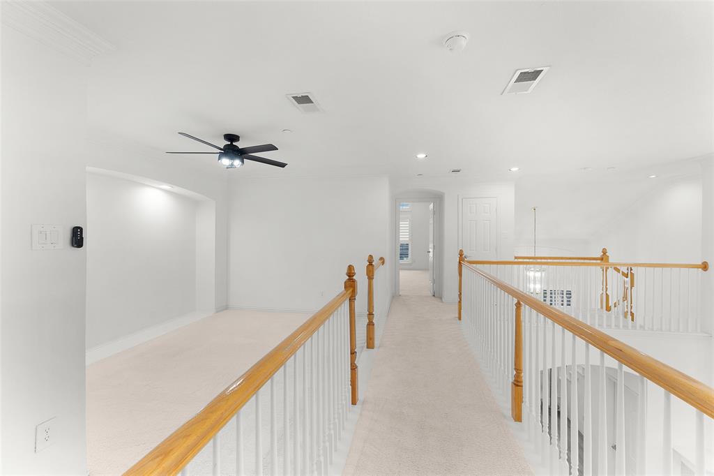 8108 Locust Street Irving, TX 75063 - Photo 28 of 39 a view of a hallway with a ceiling fan