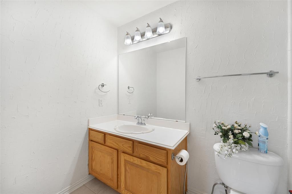 8108 Locust Street Irving, TX 75063 - Photo 31 of 39 a bathroom with a sink and mirror
