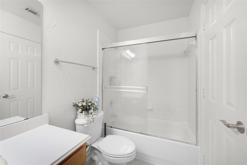 8108 Locust Street Irving, TX 75063 - Photo 32 of 39 a bathroom with a sink a toilet and shower