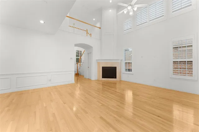 a view of empty room with a fireplace and wooden floor