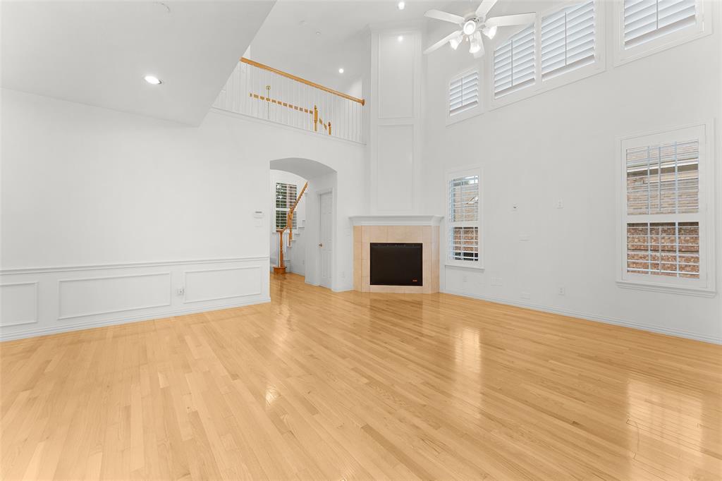 8108 Locust Street Irving, TX 75063 - Photo 7 of 39 a view of empty room with a fireplace and wooden floor