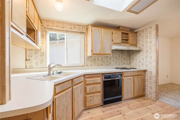 a kitchen with stainless steel appliances granite countertop a stove sink and cabinets