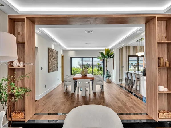 a kitchen with stainless steel appliances a kitchen island a stove a table and chairs in it