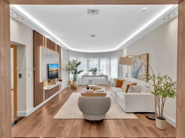 a large white kitchen with kitchen island granite countertop a large counter top and stainless steel appliances