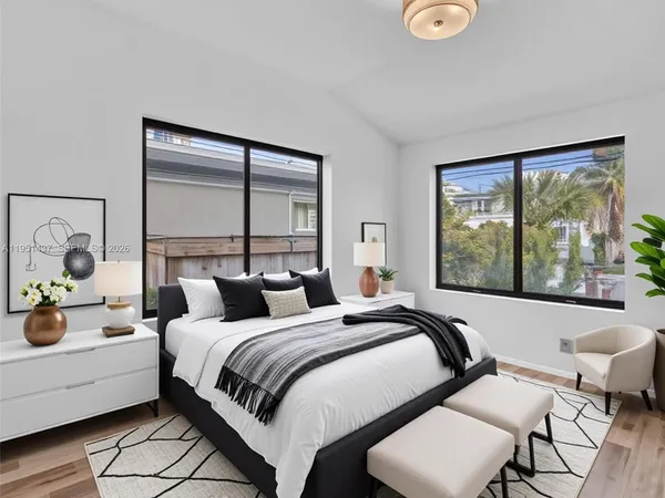 a view of a room with wooden floor and windows