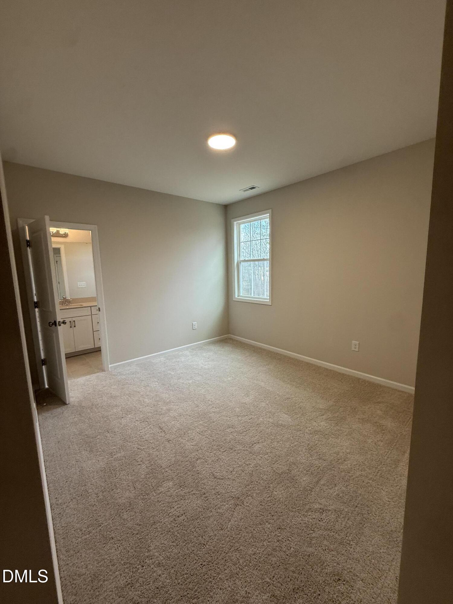 2437 Picual Way Apex, NC 27502 - Photo 18 of 31 a view of an empty room with a window