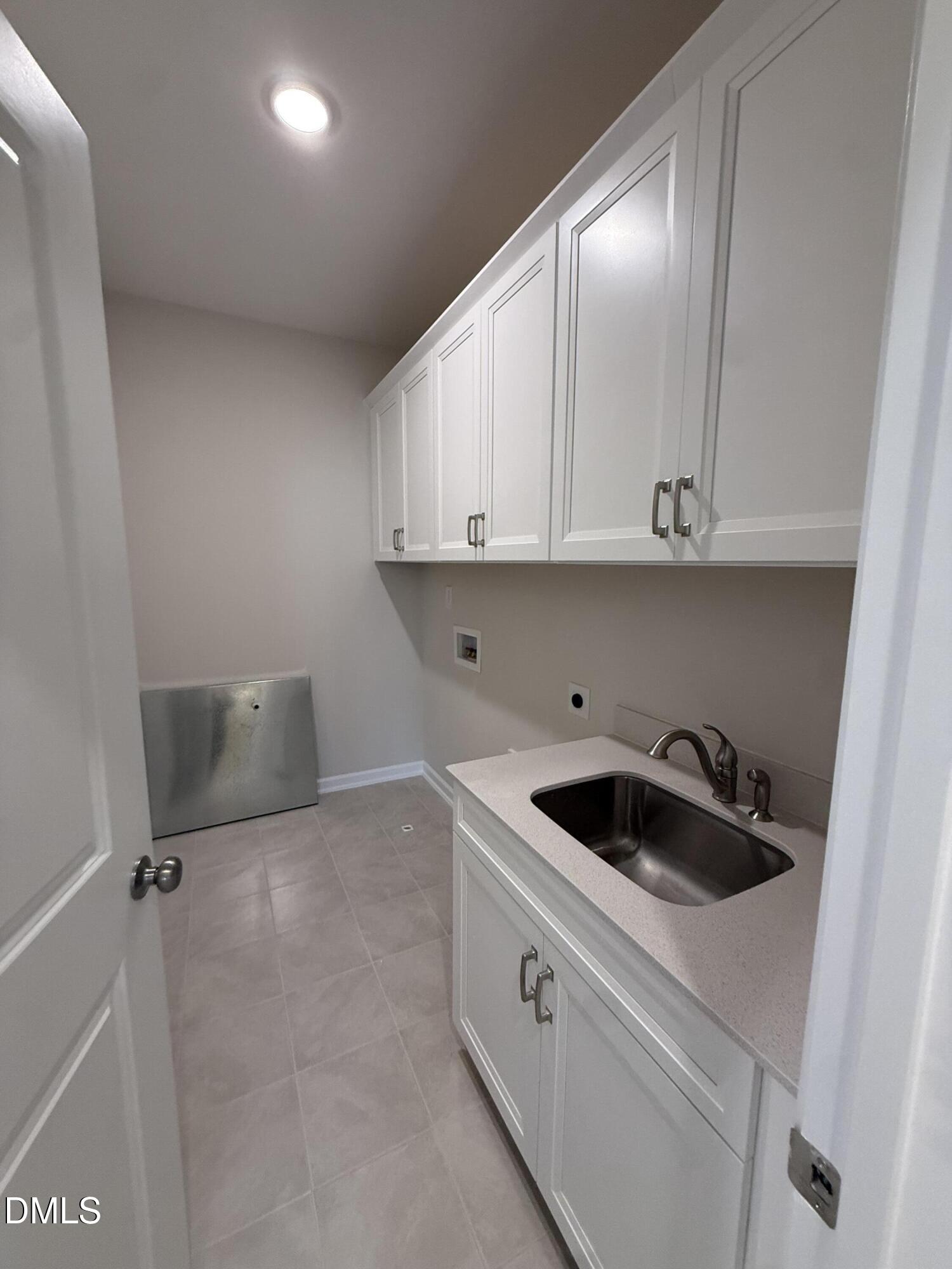 2437 Picual Way Apex, NC 27502 - Photo 20 of 31 a kitchen with a cabinets and white appliances