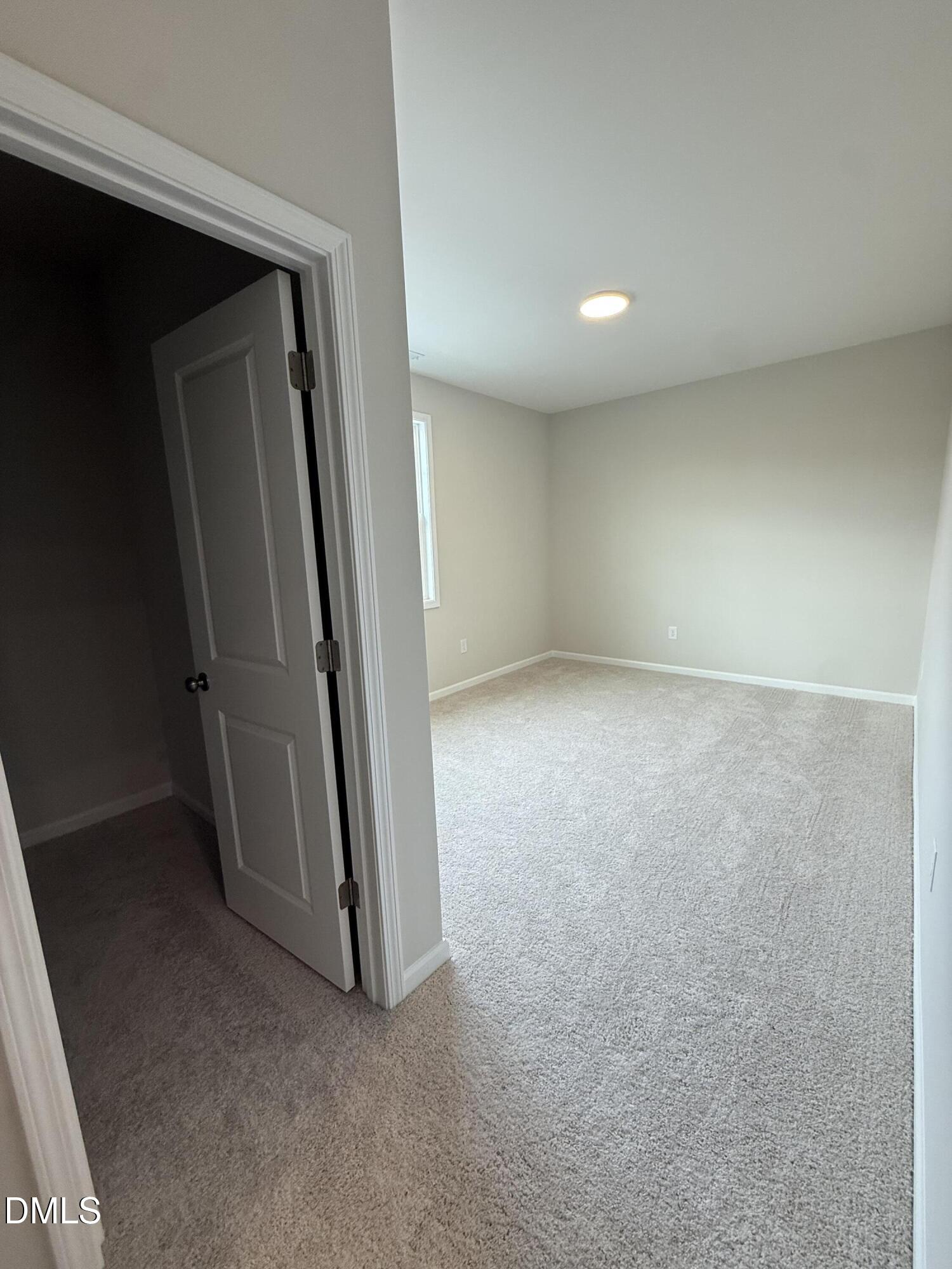 2437 Picual Way Apex, NC 27502 - Photo 22 of 31 an empty room with a door