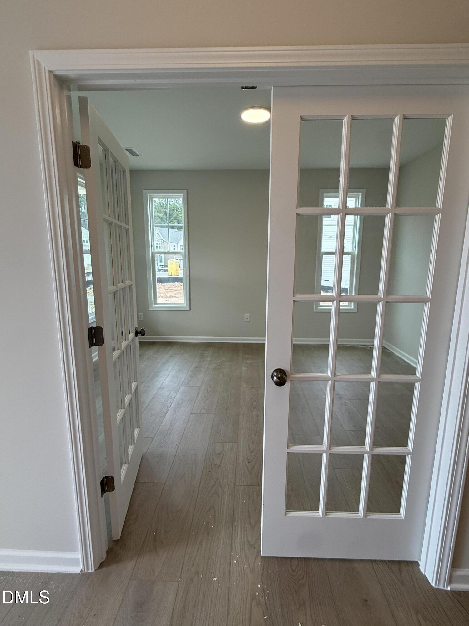 2437 Picual Way Apex, NC 27502 - Photo 3 of 31 a view of a hallway with wooden floor and entryway