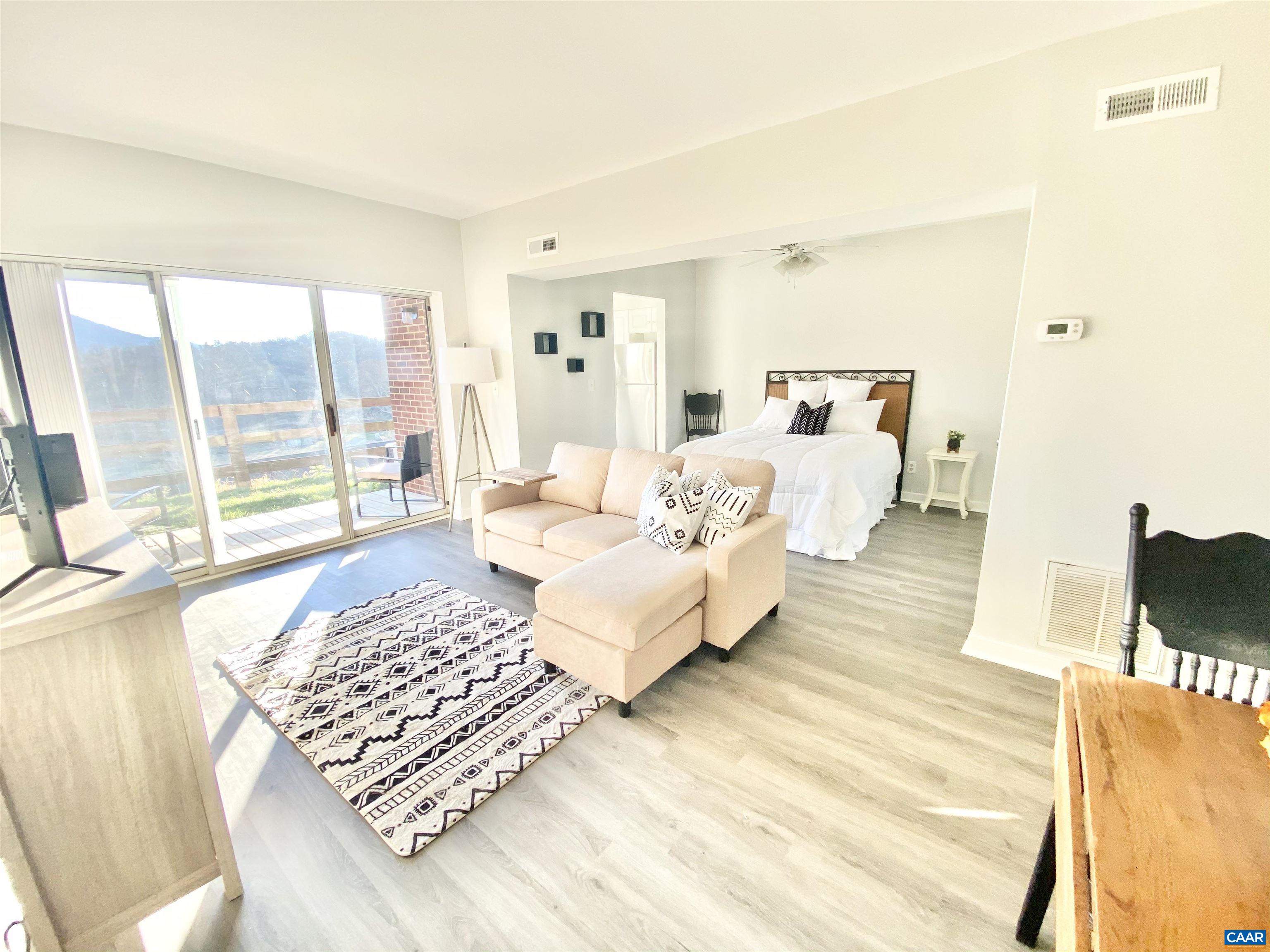 1608 A Monticello Avenue Charlottesville, VA 22902 - Photo 1 of 16 a bedroom with a bed and wooden floor