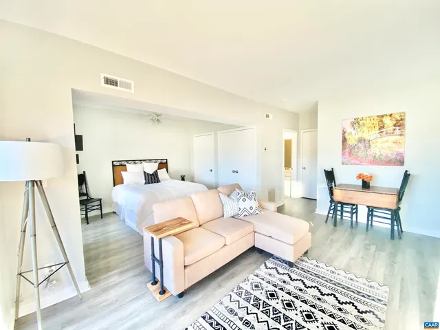 a bedroom with a bed and wooden floor