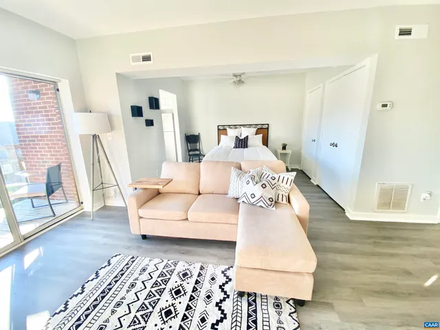 a living room with furniture and wooden floor