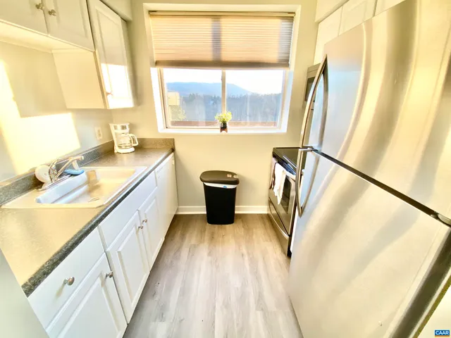 a bathroom with a sink a large mirror and a bathtub