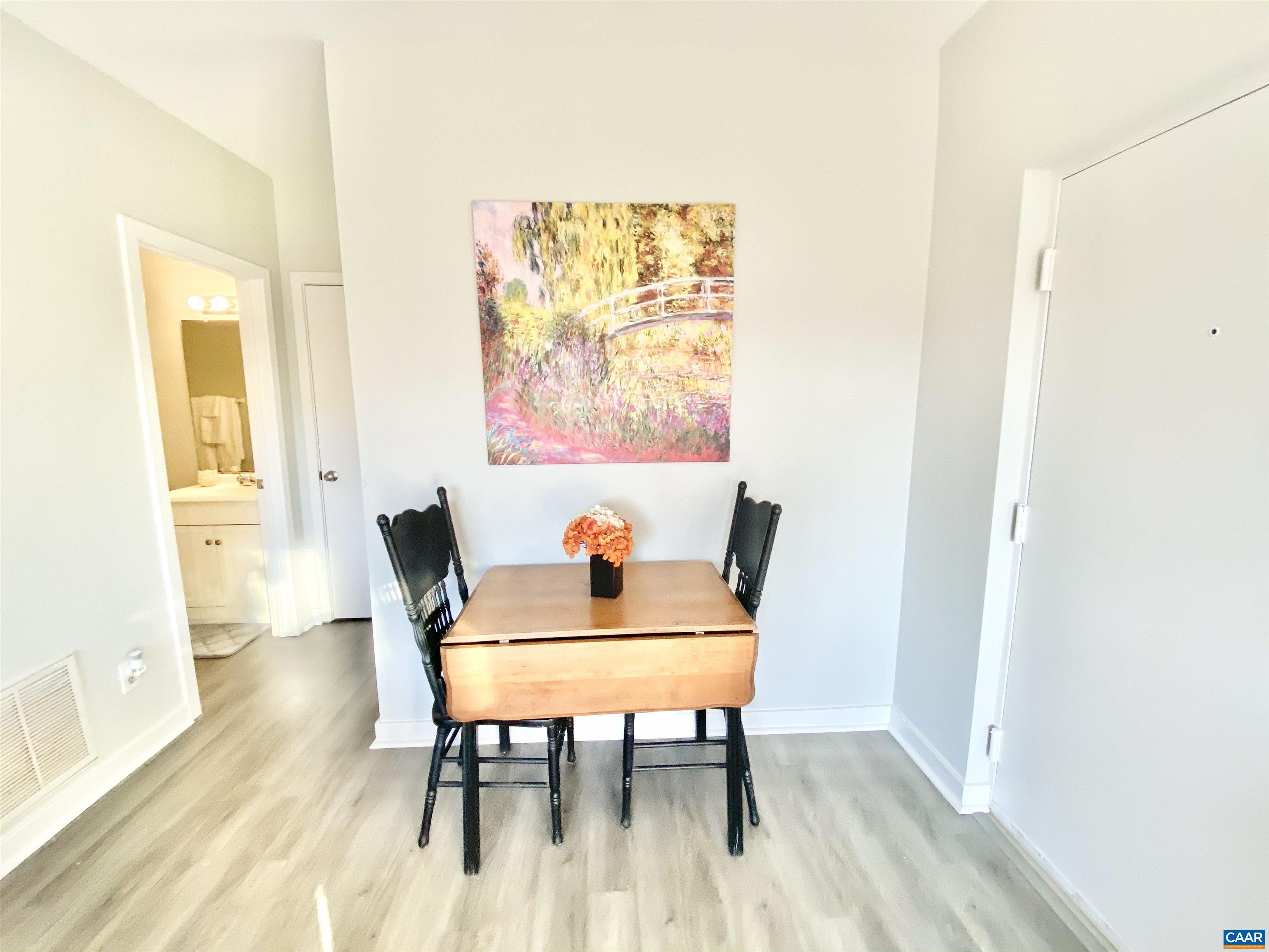 1608 A Monticello Avenue Charlottesville, VA 22902 - Photo 8 of 16 a view of a dining room with furniture and wooden floor