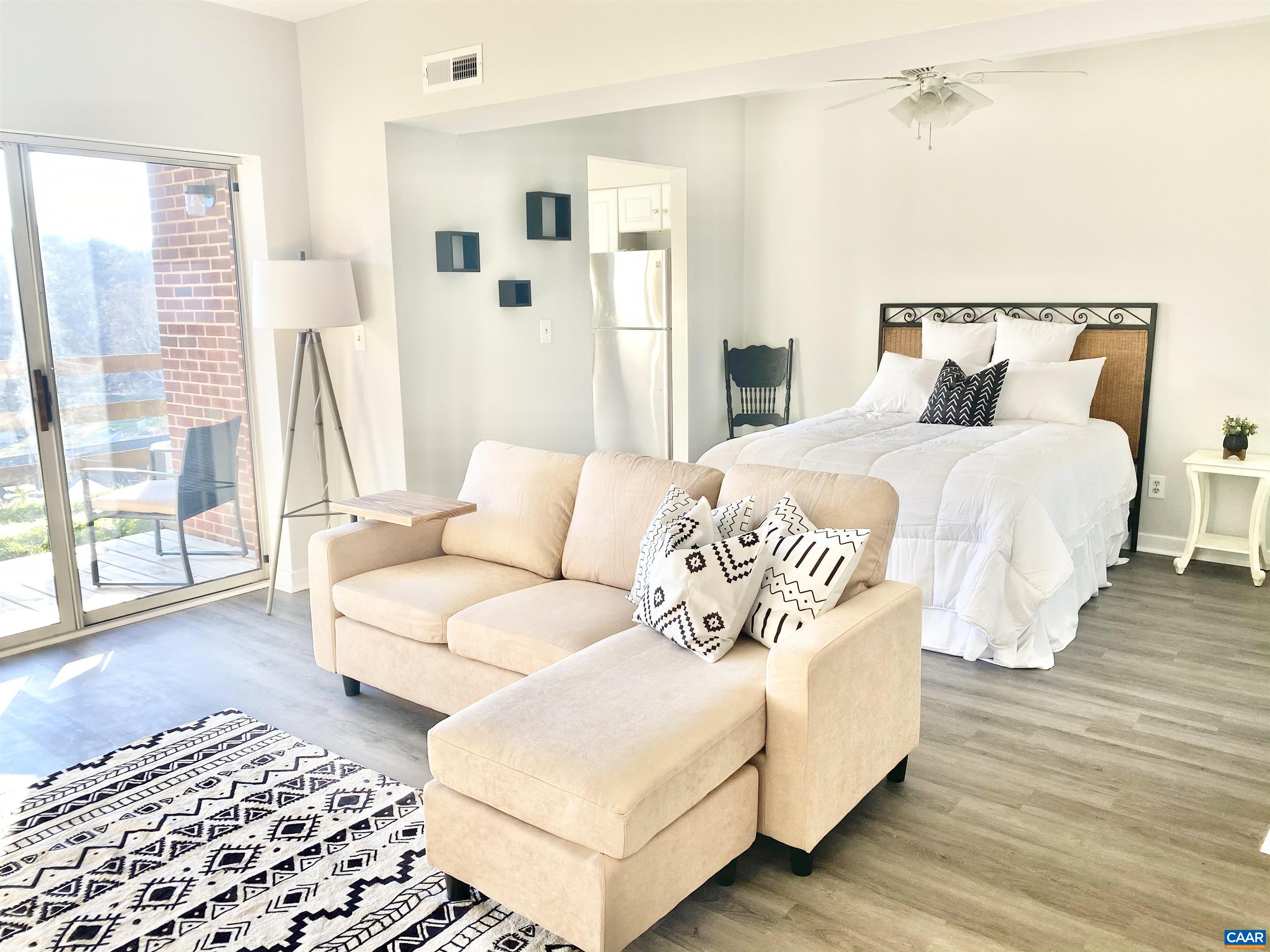 1608 A Monticello Avenue Charlottesville, VA 22902 - Photo 9 of 16 a bedroom with a bed lamp and a large window