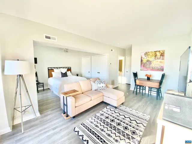 a bedroom with furniture and a rug