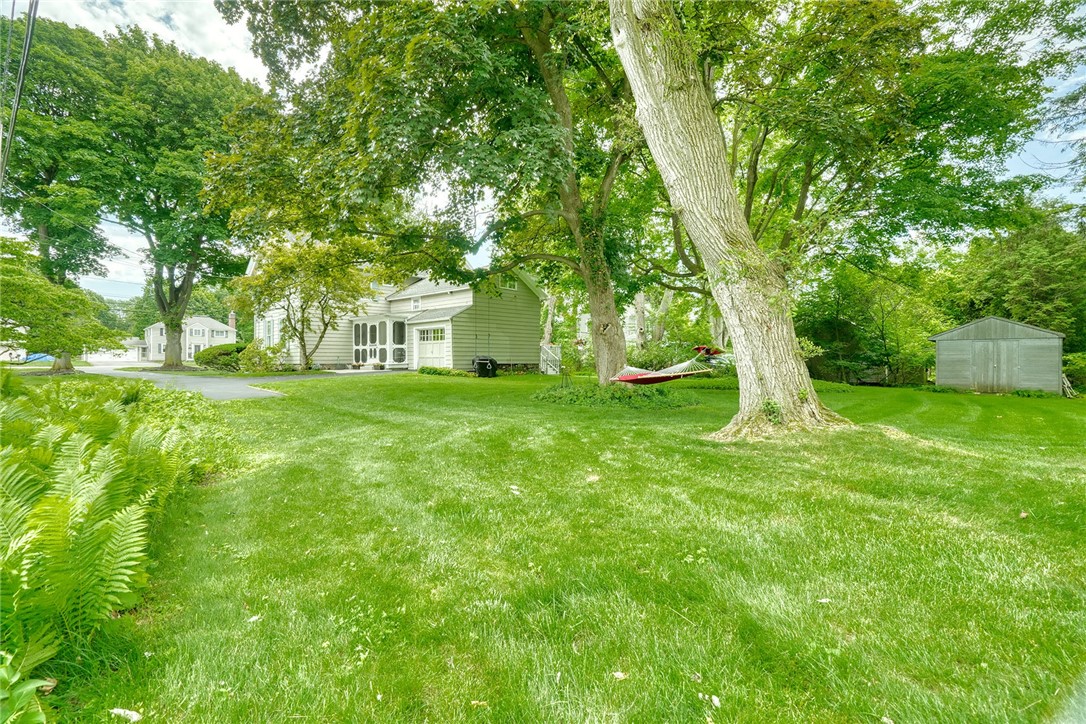 1479 Creek Street Rochester, NY 14625 - Photo 46 of 50 SIDE YARD VIEW TO HOUSE & SHEDS
