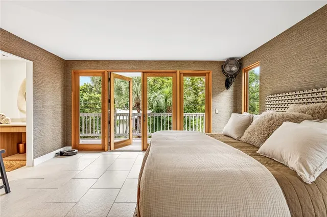 a bedroom with a large bed and a large window