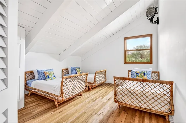 a bedroom with furniture and wooden floor
