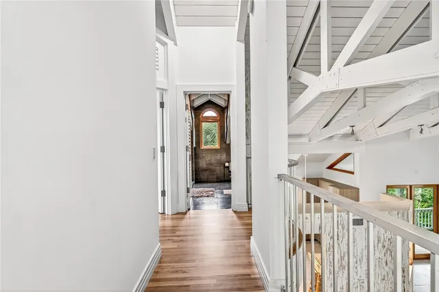 a view of a hallway with wooden floor and staircase