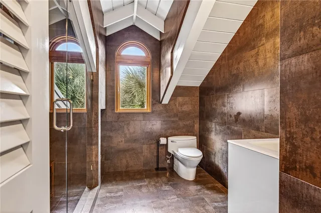 a bathroom with a toilet sink and shower