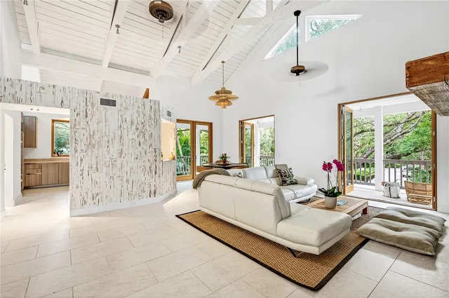 a living room with patio furniture and a large window
