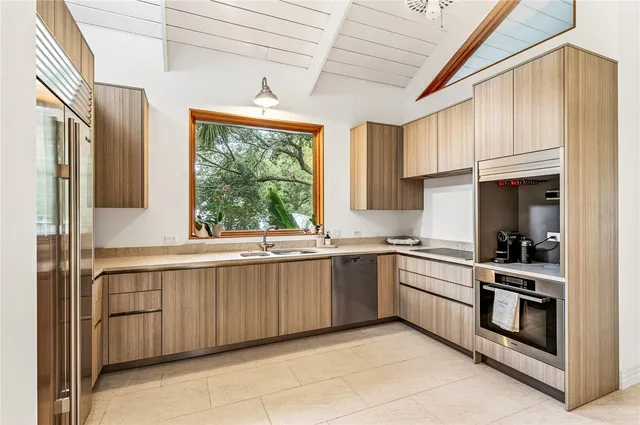 a kitchen with a sink stove and cabinets