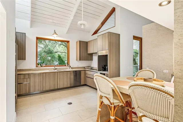 a kitchen with a sink appliances and windows