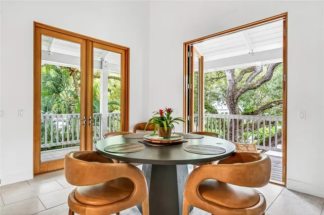 a dining room with furniture and a floor to ceiling window