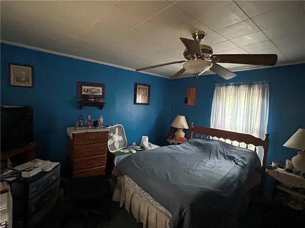 a bedroom with bed and a window