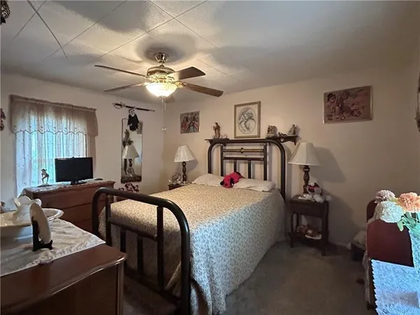 a bedroom with bed and a chandelier