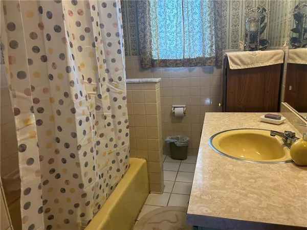 a bathroom with a sink a toilet and a shower