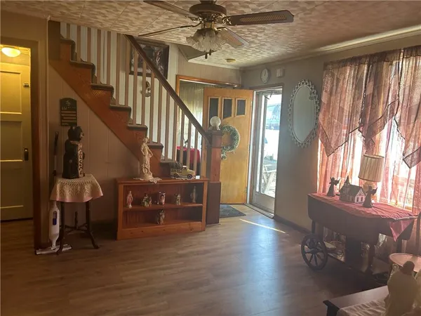 a view of entryway and hall with wooden floor