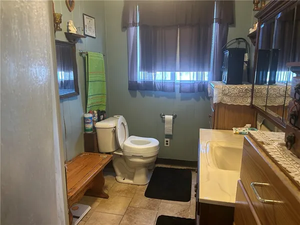 a bathroom with a toilet sink and mirror