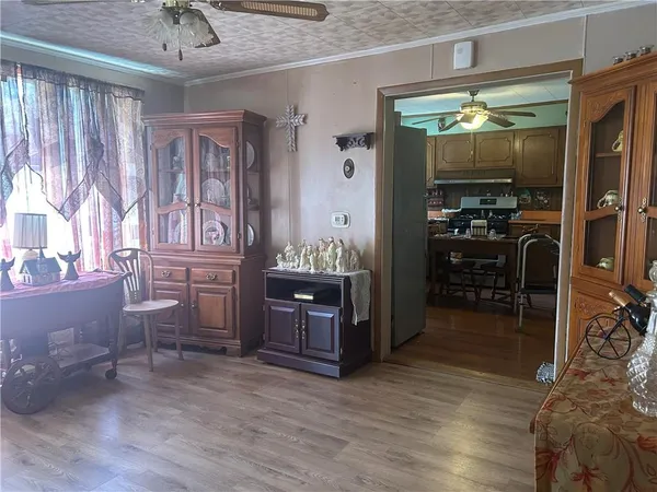 a room with furniture a chandelier and a wooden floor