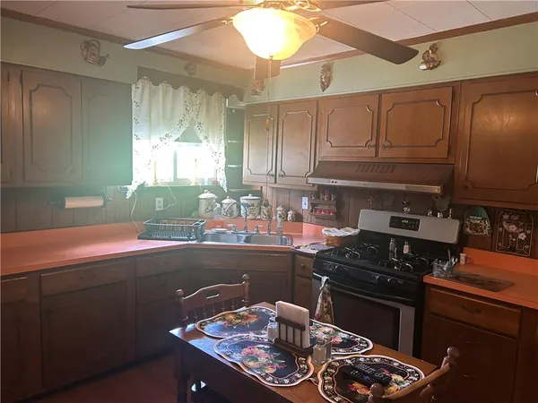 a kitchen with a sink and wooden cabinets