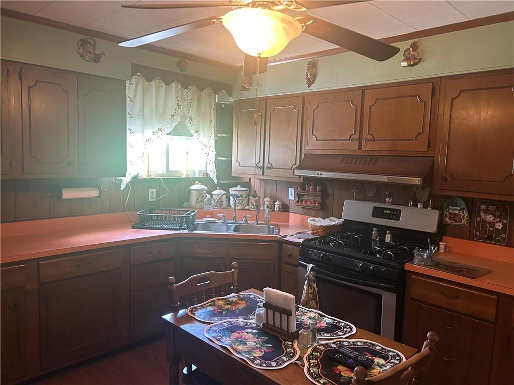 42 Walnut Avenue Dunbar, PA 15431 - Photo 24 of 31 a kitchen with a sink and wooden cabinets