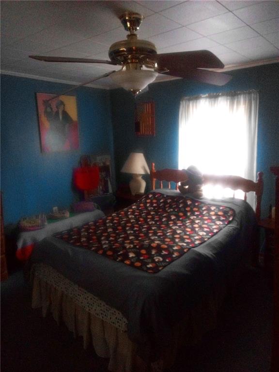 42 Walnut Avenue Dunbar, PA 15431 - Photo 27 of 31 a bed sitting in a bedroom next to a window and a chandelier