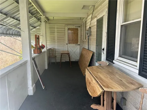 a balcony with table and chairs