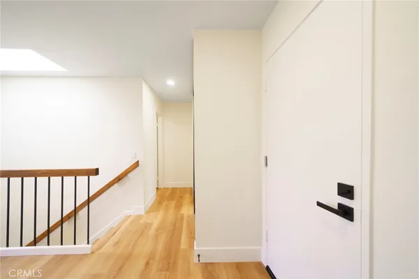 a view of hallway with wooden floor
