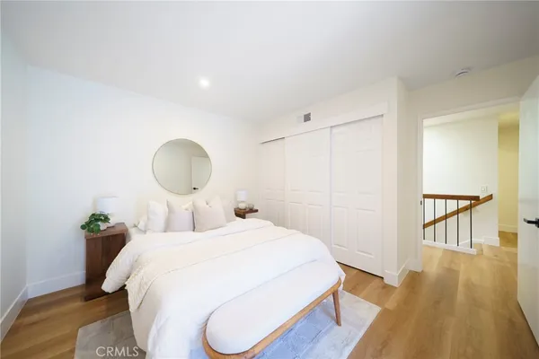 a bedroom with a bed and wooden floor